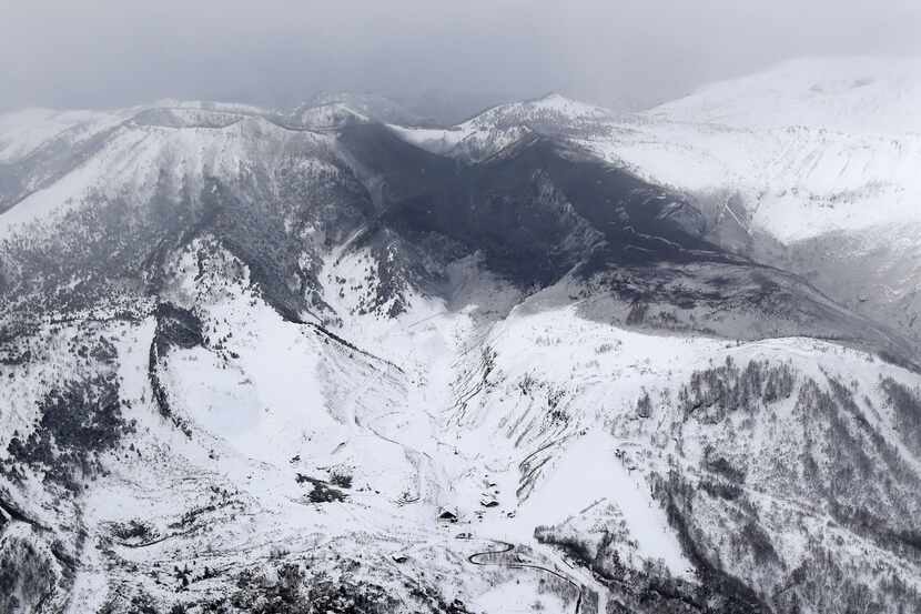 Ashes from Mount Kusatsu-Shirane cover near its summit after its eruption in Kusatsu, Gunma...