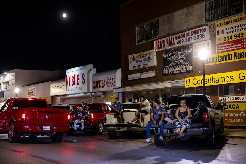 Familes watch as people cruise in their cars on Sunday, Sept. 19, 2021, on Jefferson...