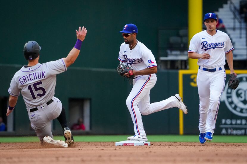 Texas Rangers second baseman Marcus Semien beats Colorado Rockies center fielder Randal...