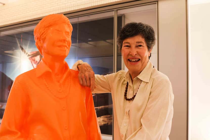 Lyda Hill, founder of LH Capital Inc., poses next to her own sculpture in the exhibit at...