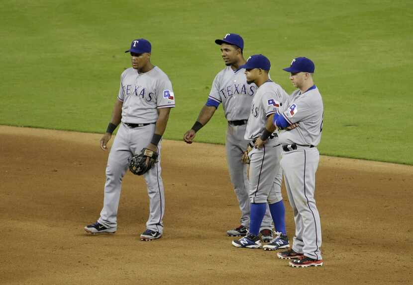 Texas Rangers third baseman Adrian Beltre, left, shortstop Elvis Andrus, second from left,...