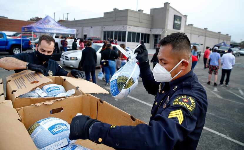 Dallas Police Department Unidos outreach team members Sgt. Eddie Reyes (right) and Lt....