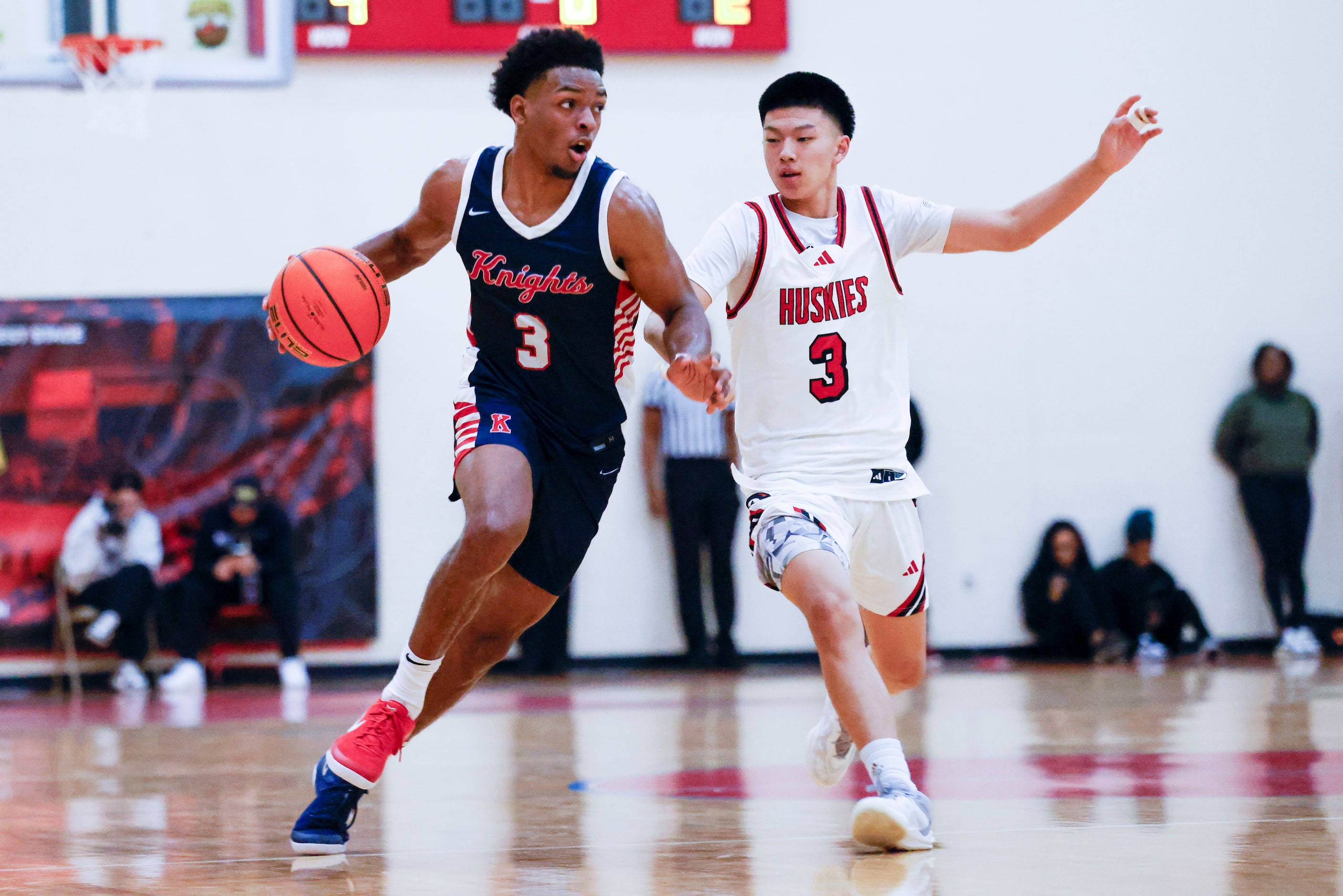 Kimball High’s David Coe (left) dribbles past Jayden Yim of Centennial High of California...