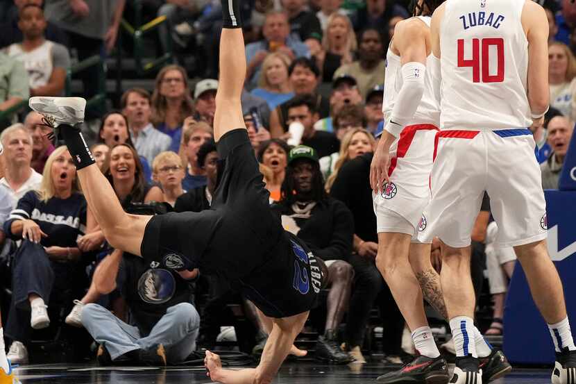 Dallas Mavericks forward Maxi Kleber (42) crashes to the floor after being upended in front...