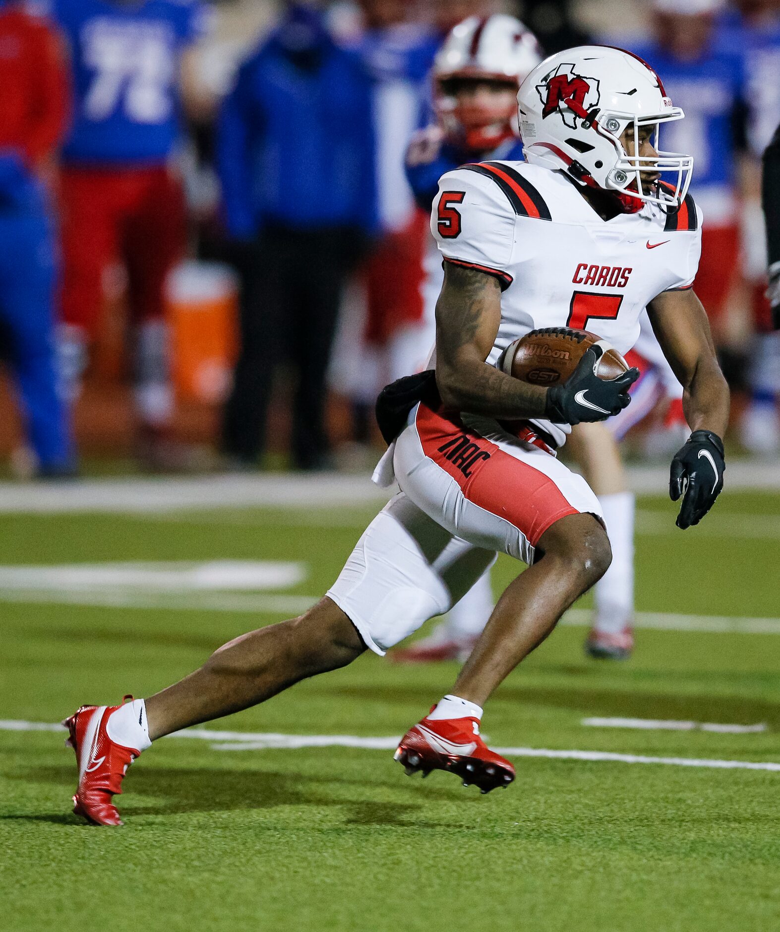 Irving MacArthur senior Demond White (5) carries the ball during the first half of a high...