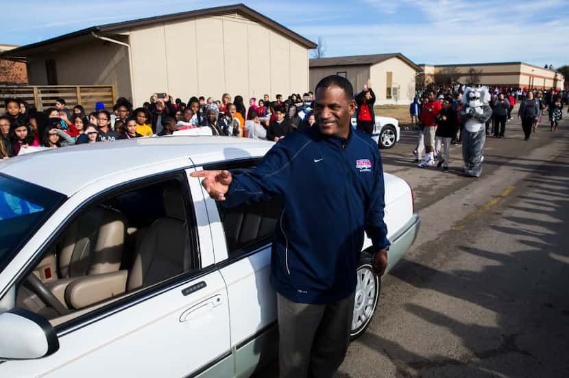 Teachers aide Kevin MaBone is surprised with a car during a presentation by students and...