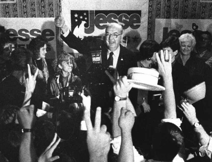 Sen. Jesse Helms, R-N.C., gives the thumbs-up to his supporters at the Brownstone Hotel...