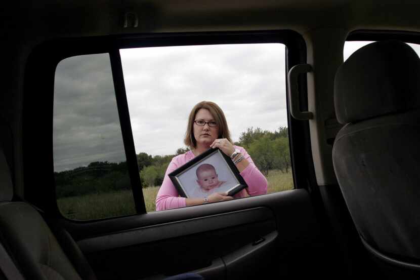 Michele Terry of Maypearl holds a photo of her daughter Mika, who died after being left in a...