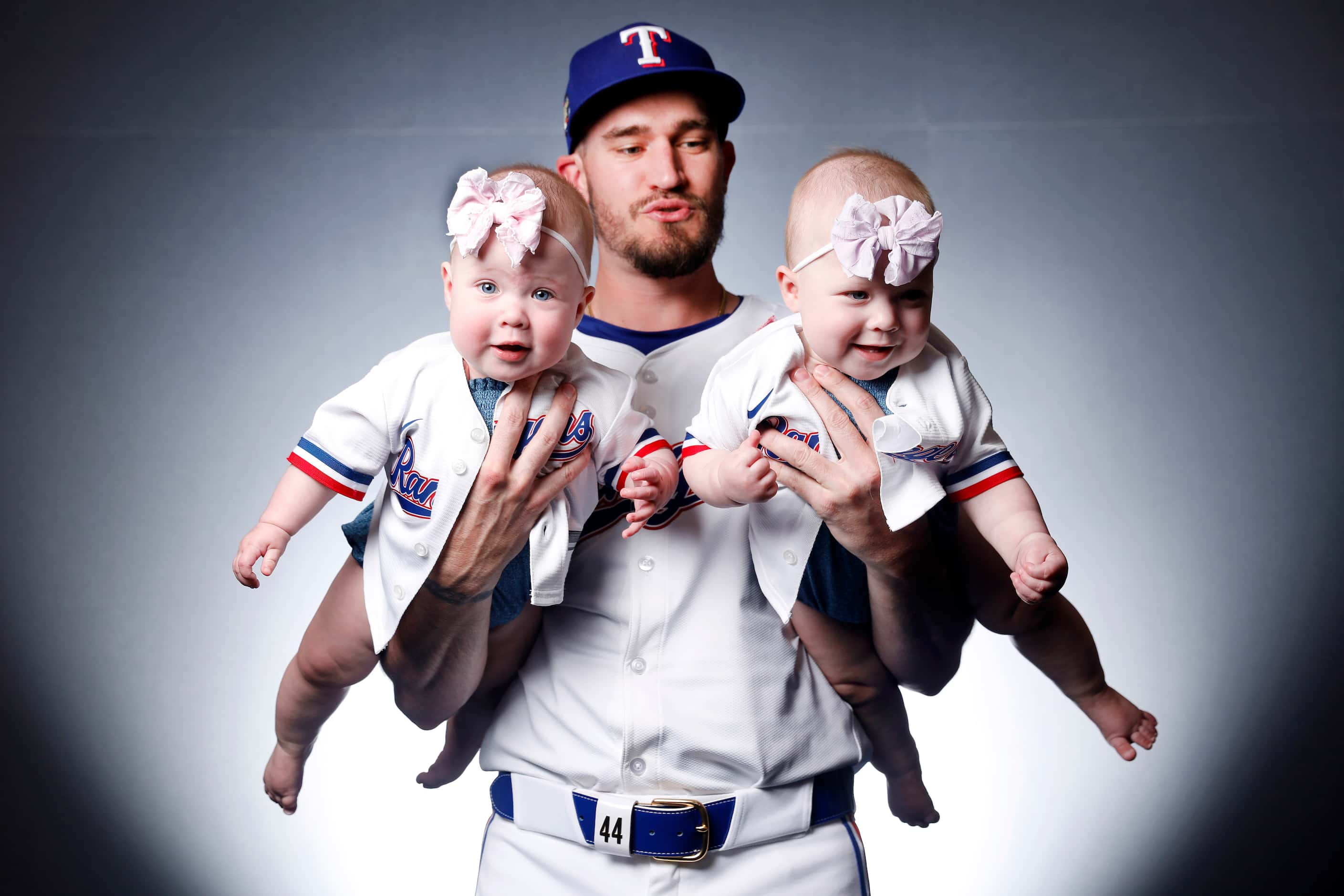 Texas Rangers Andrew Heaney pictured with his newborn twin children Eleanor (right) and...