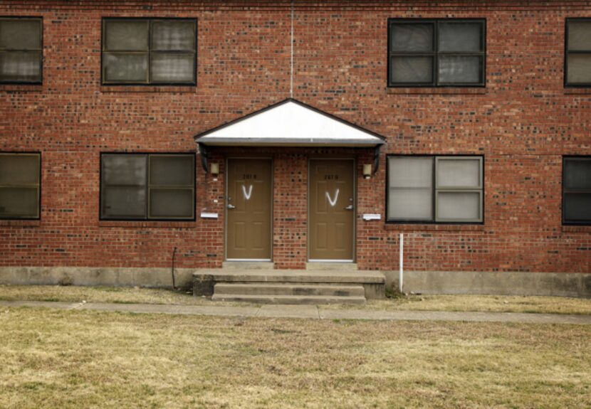 Spray-painted "V's" denote vacant apartments at Cedar Springs Place public housing unit in...