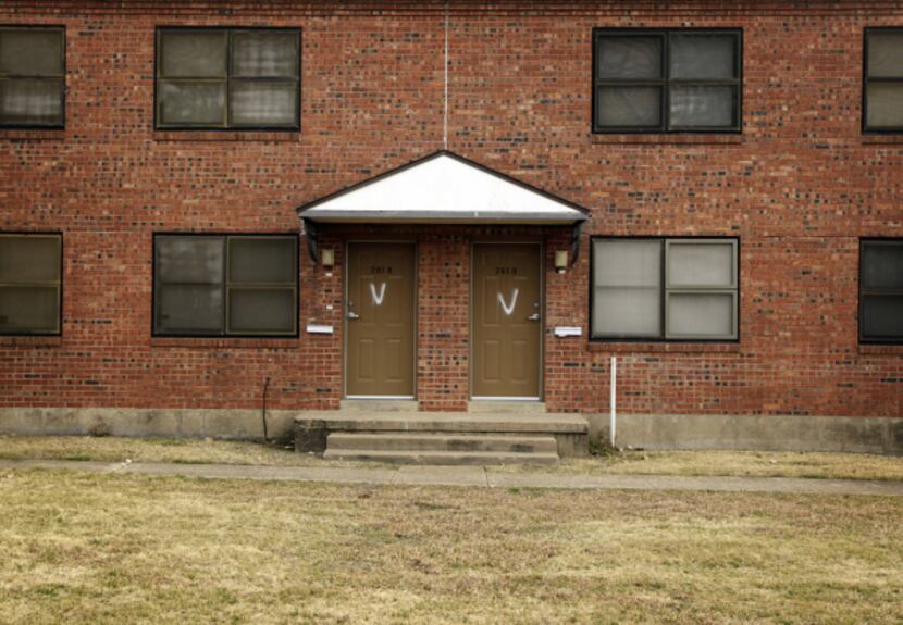 Spray-painted "V's" denote vacant apartments at Cedar Springs Place public housing unit in...