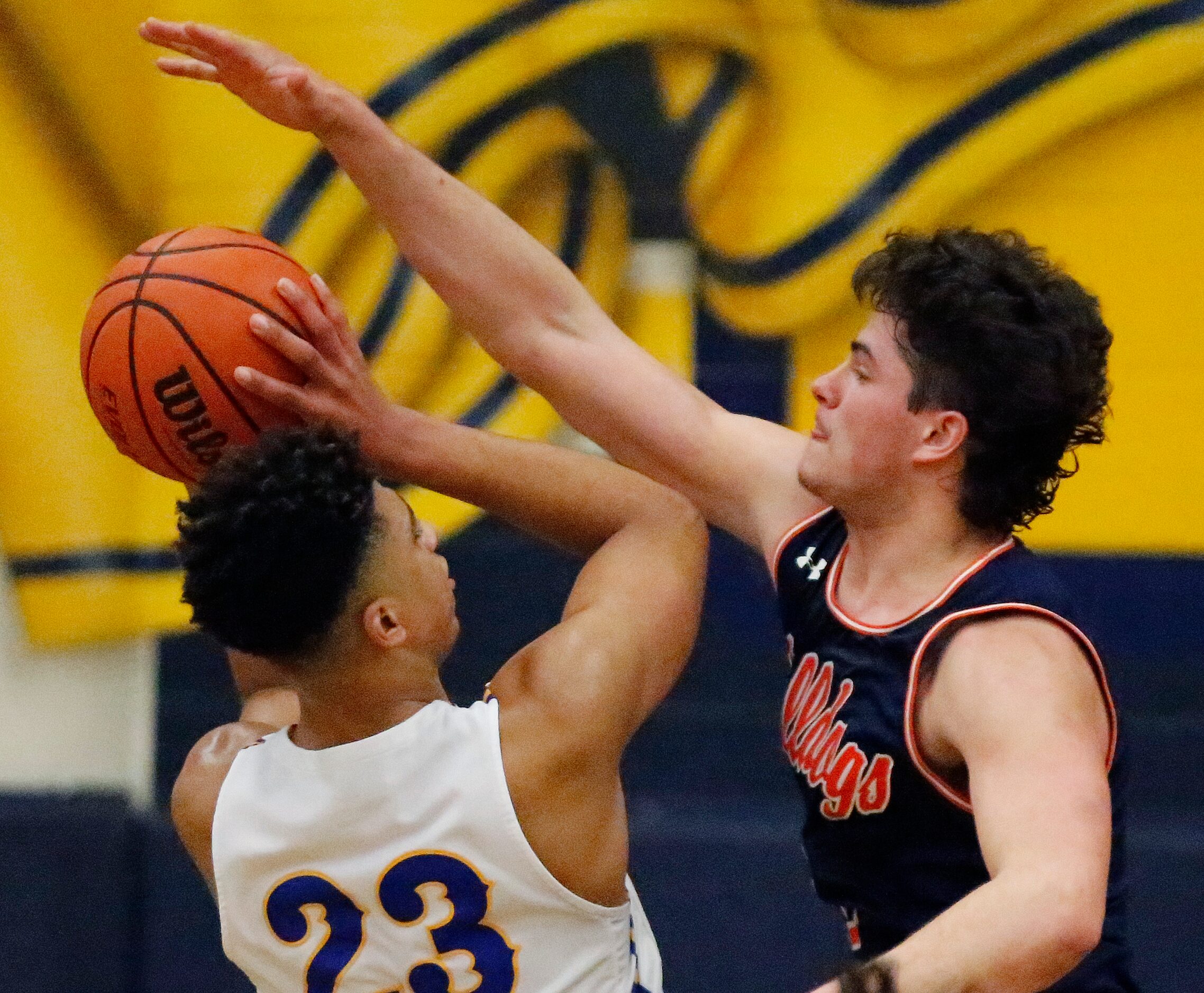 Frisco High School forward Jovani Benae (23) has a shot blocked by McKinney North High...