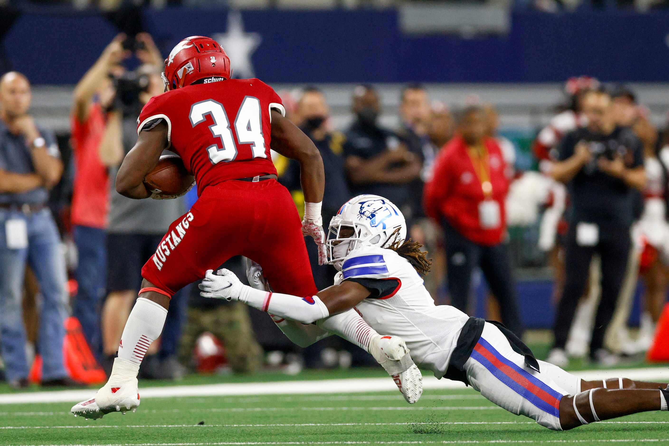 Duncanville defensive back Deldrick Madison (4) tackles Galena Park North Shore running back...