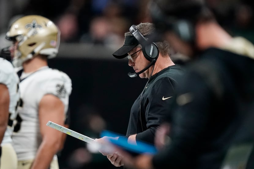 New Orleans Saints head coach Sean Payton looks over plays on the sidelines during the first...
