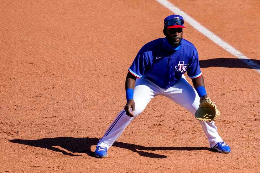 Texas Rangers infielder Sherten Apostel works at first base during the sixth inning of a...