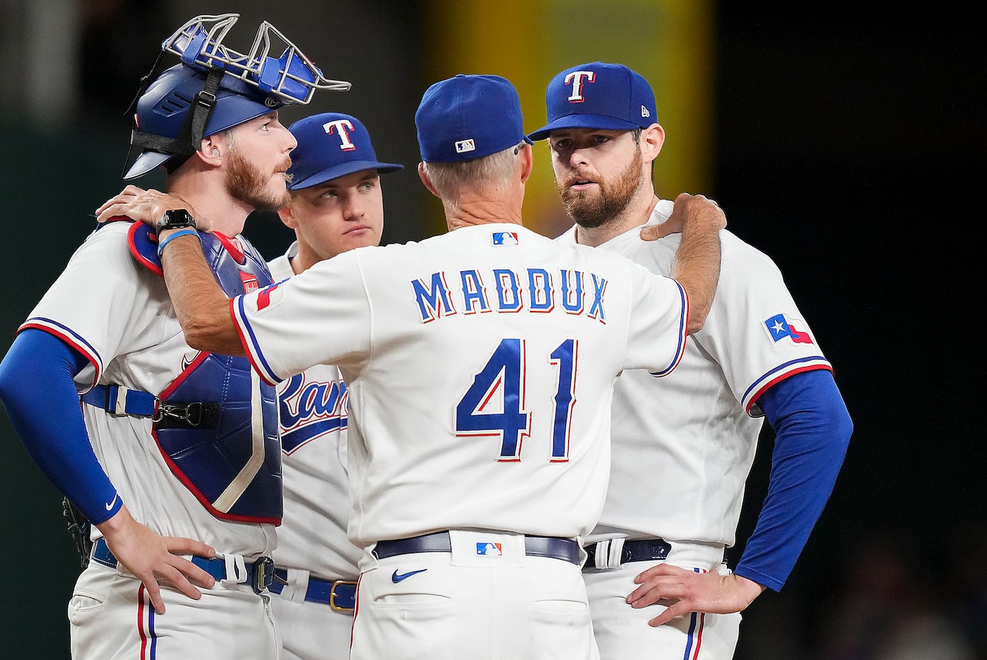 Texas Rangers starting pitcher Jordan Montgomery (52) gets a visit from pitching coach Mike...