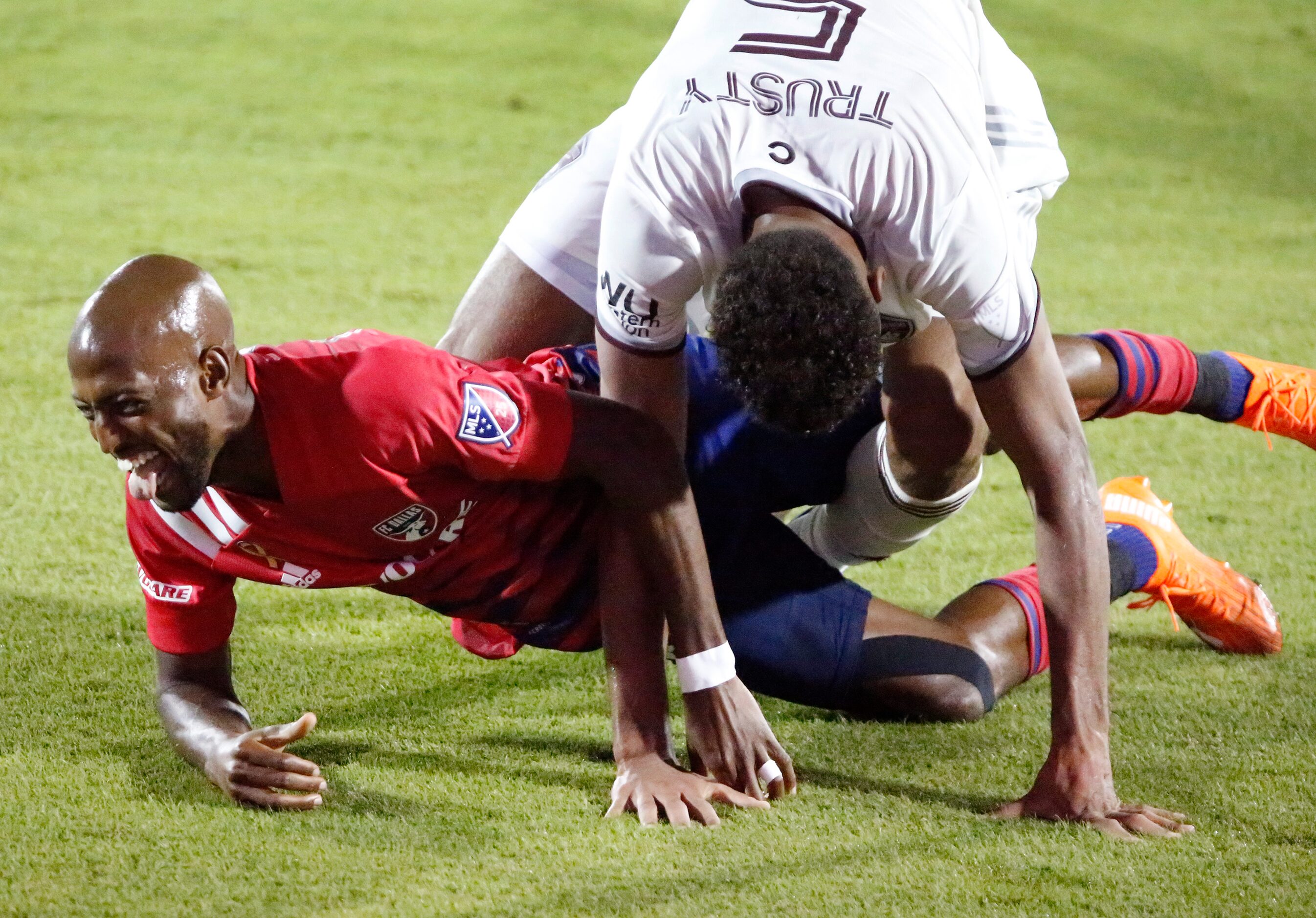 FC Dallas forward Fafa Picault (9) gets tangled with Colorado Rapids defender Auston Trusty...