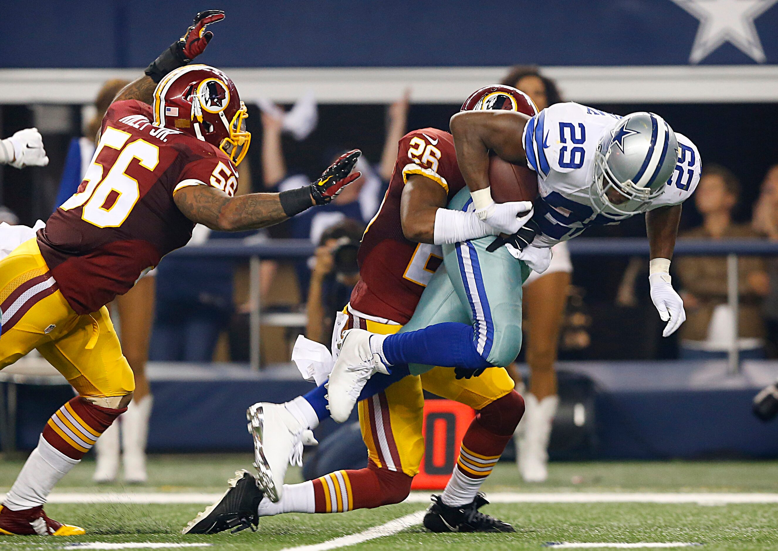 Dallas Cowboys running back DeMarco Murray (29) is brought down by Washington Redskins free...