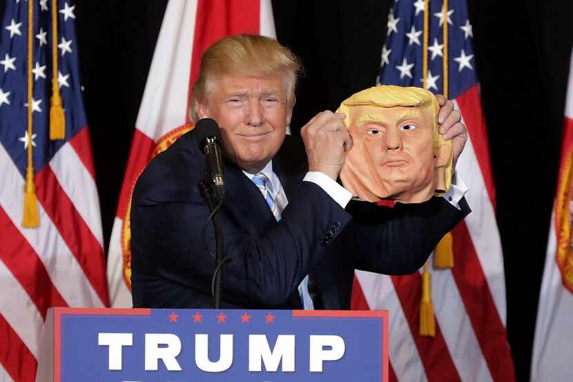 SARASOTA, FL - NOVEMBER 07:  Republican presidential nominee Donald Trump holds up a rubber...