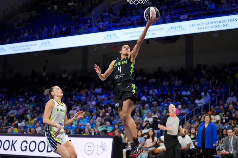Seattle Storm guard Skylar Diggins-Smith (4) scores on a breakaway, next to Dallas Wings...
