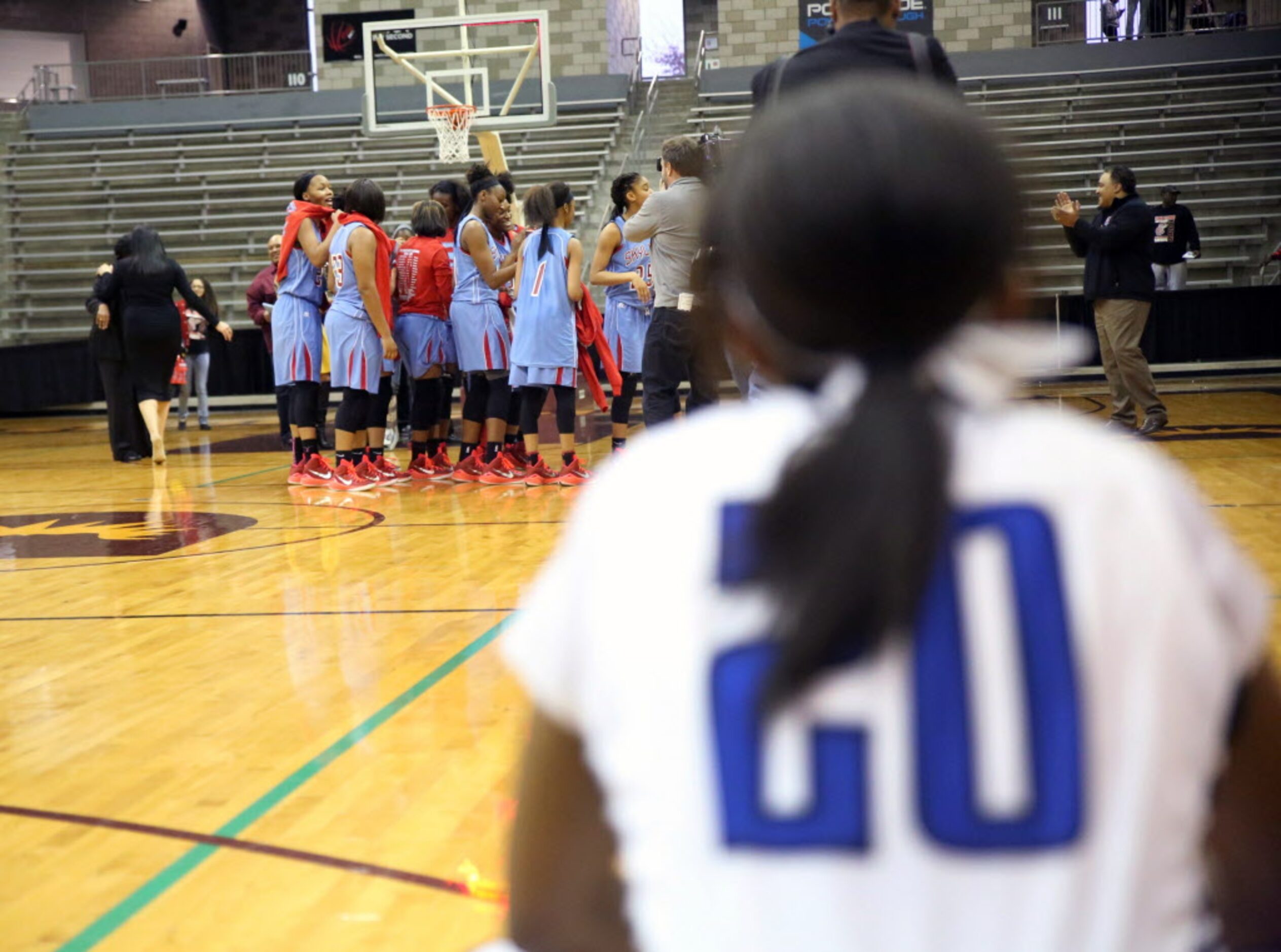 Dekaney point guard Jaelyn Richard-Harris watches the Skyline Raiders celebrate their region...