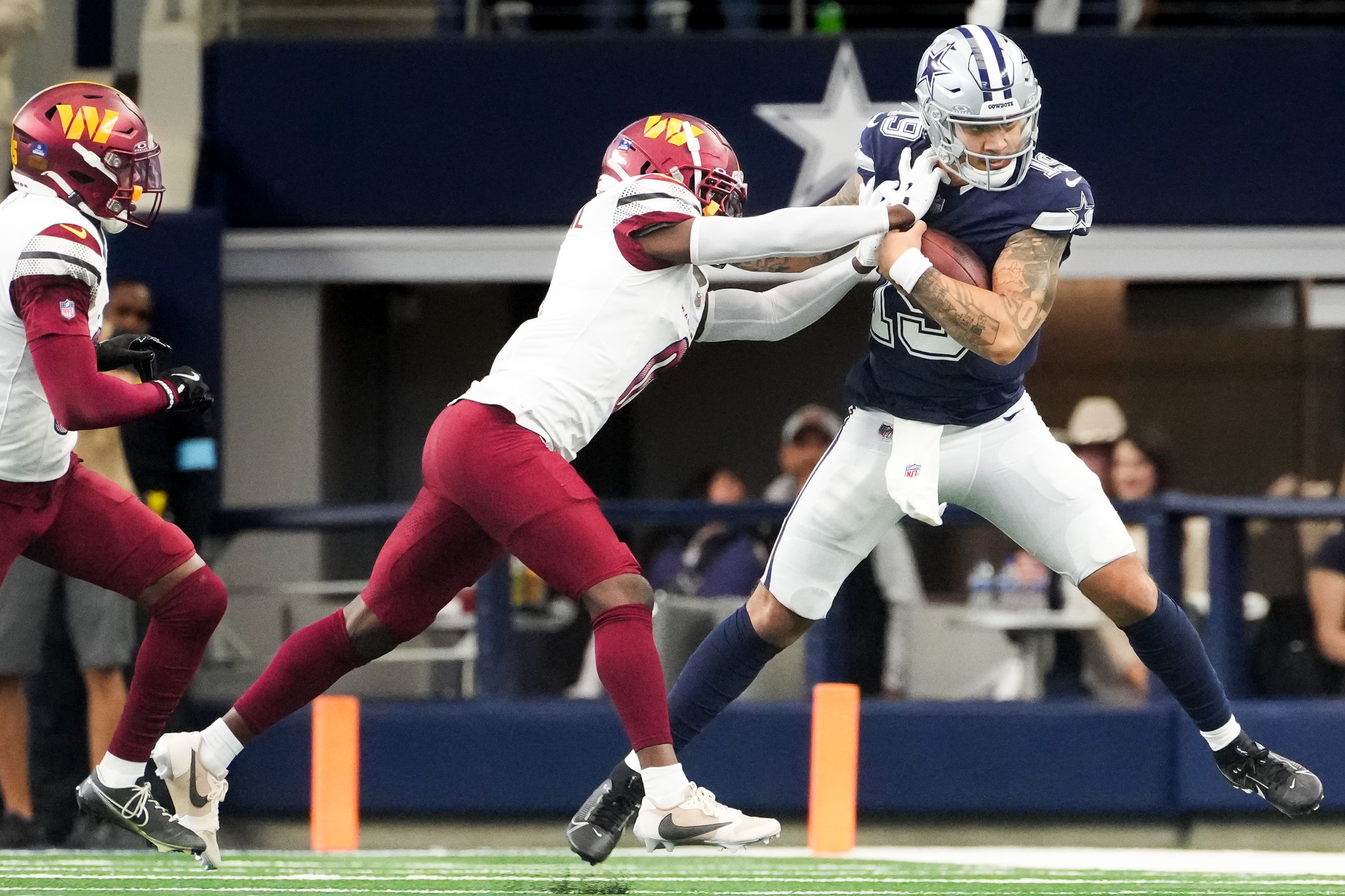 Dallas Cowboys quarterback Trey Lance (19) is pushed out of bounds by Washington Commanders...