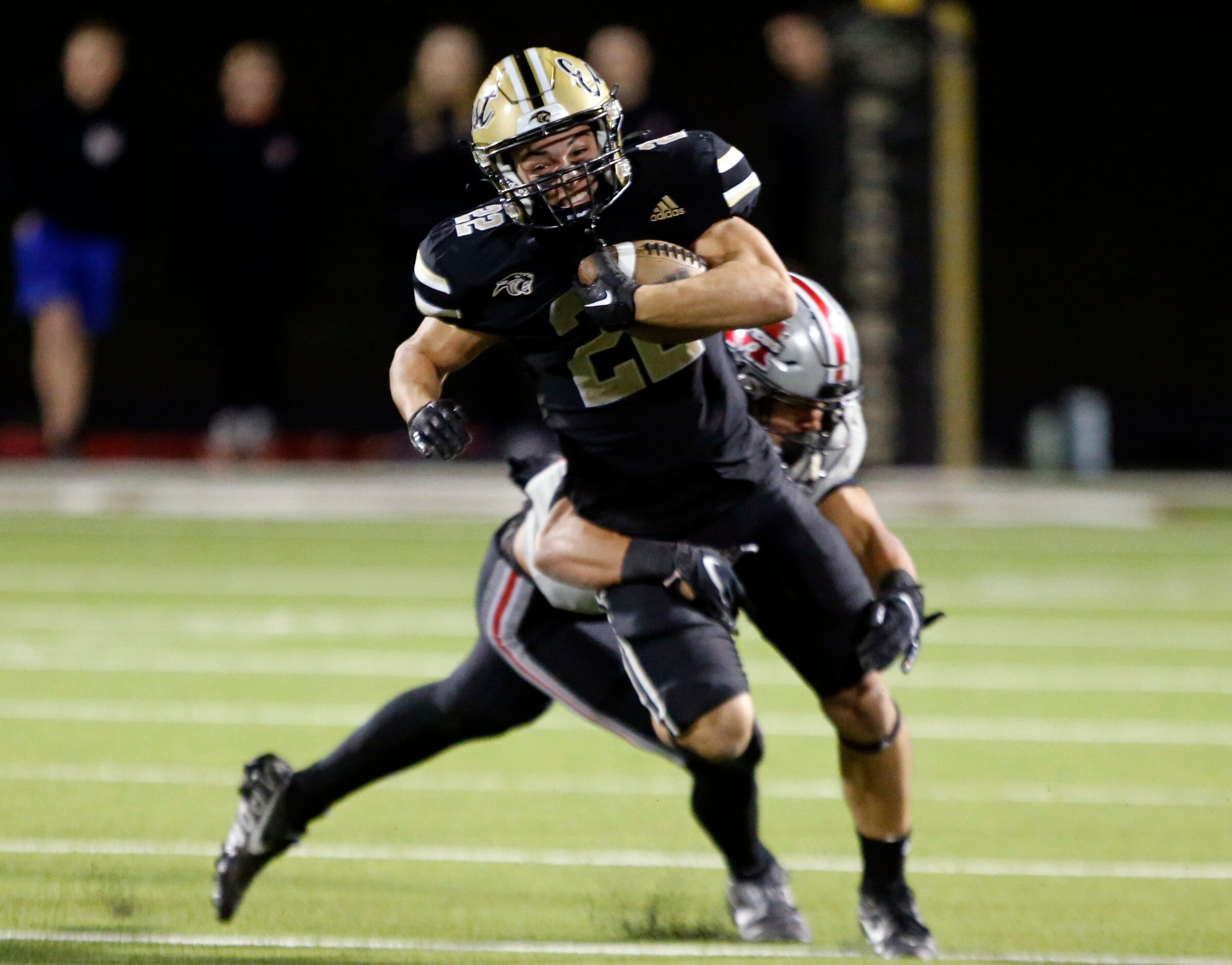 Plano East high RB Travis Agee (22) picks up yardage during the first half of a high school...