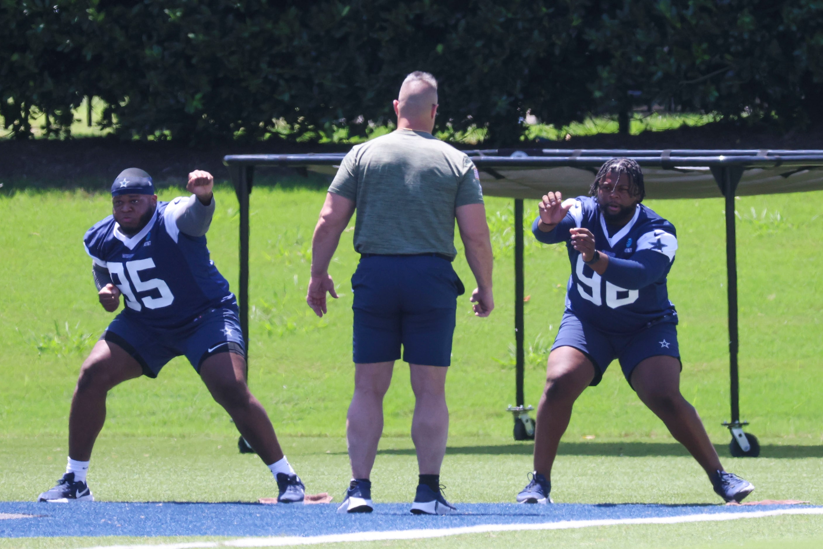 Dallas Cowboys defensive Lin eDenzel Daxon (left) and Justin Rogers (right) train with a...