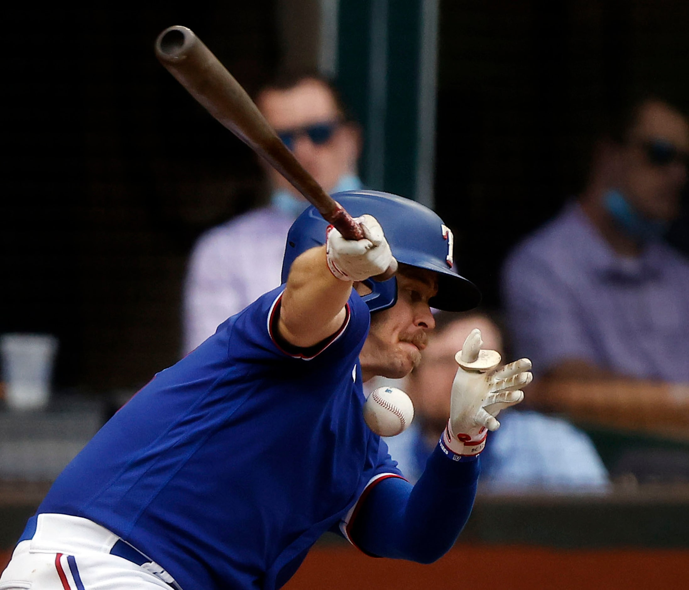 Texas Rangers batter Brock Holt (16) fouls a ball off his chest in the first inning against...