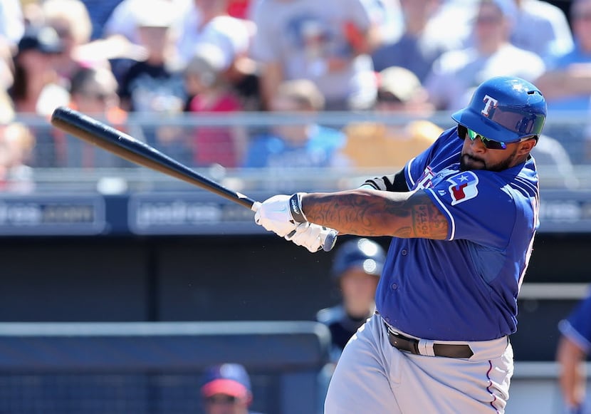 PEORIA, AZ - MARCH 09: Prince Fielder #84 of the Texas Rangers hits a RBI double against the...