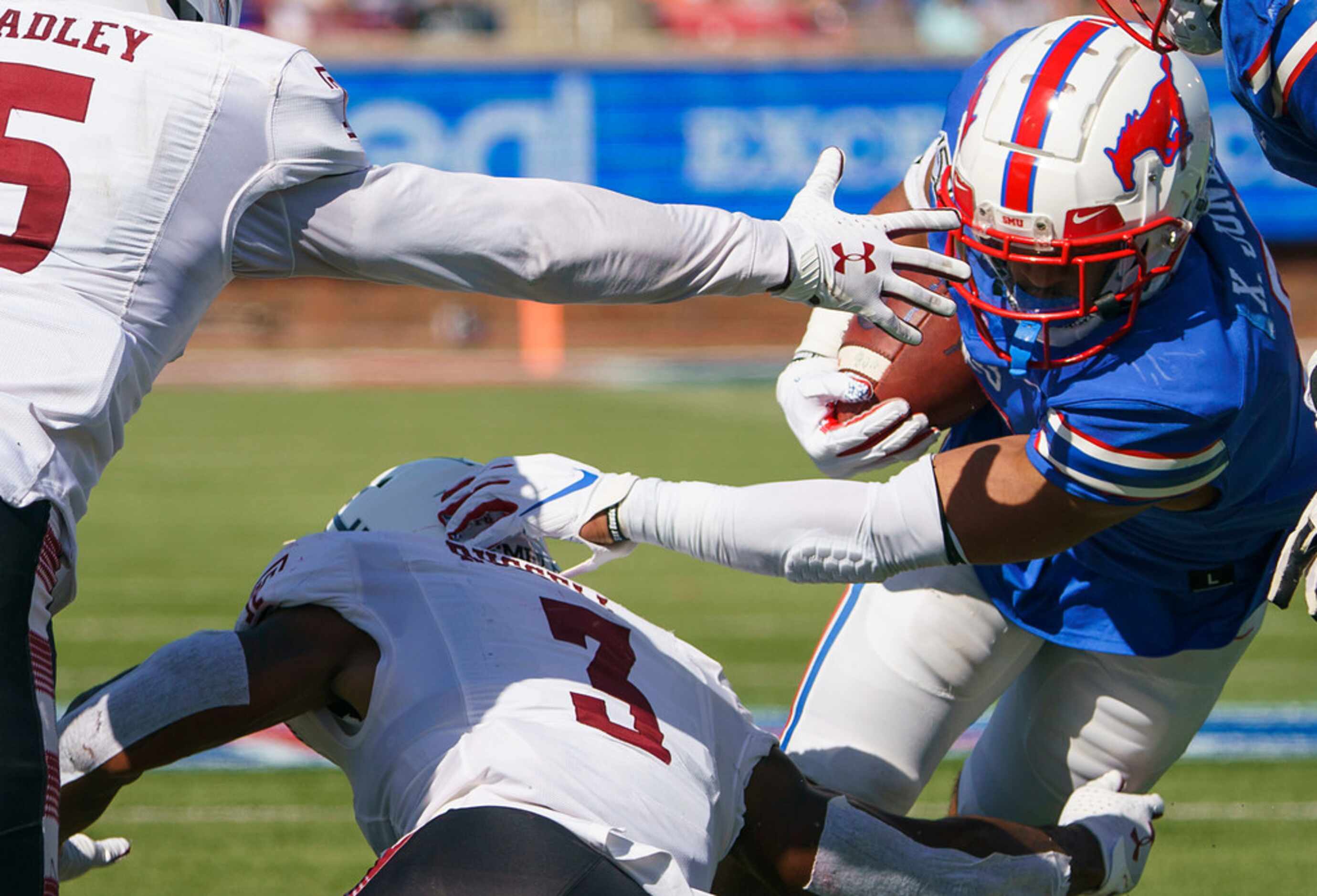 SMU running back Xavier Jones (5) tries to get past Temple linebacker Chapelle Russell (3)...