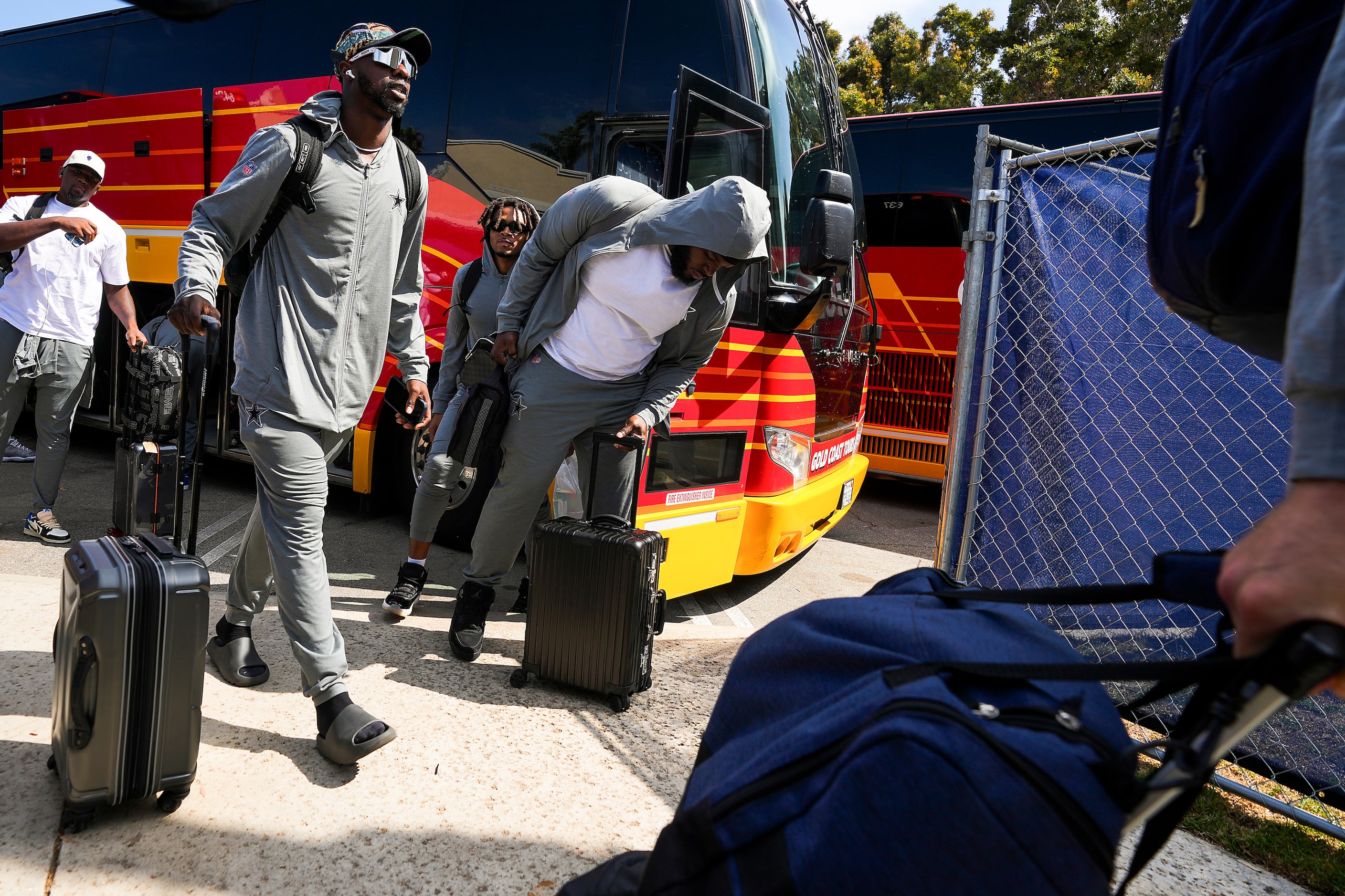 Dallas Cowboys players exit the team’s buses as they arrive for training camp on Monday,...