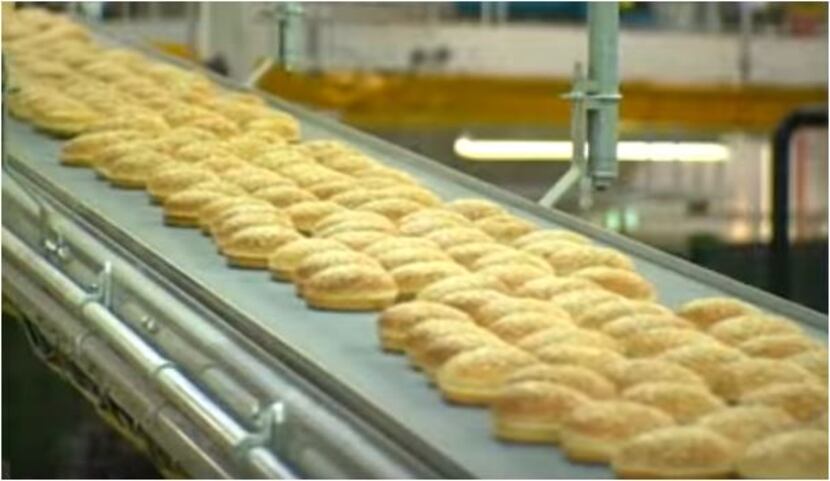 Buns roll through a Flowers Food bakery, as shown in this company promotional video.