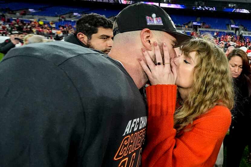 Taylor Swift kisses Kansas City Chiefs tight end Travis Kelce after an AFC Championship NFL...