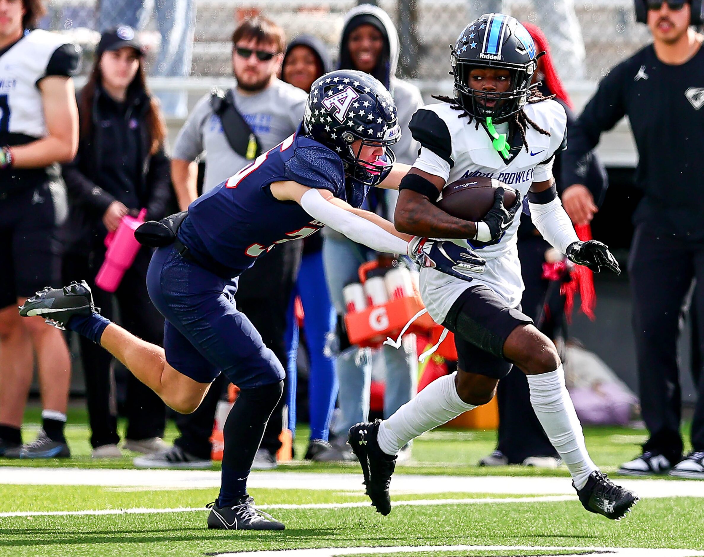 North Crowley wide receiver Dekoryian West-Davis (3) tries to fight off a tackle from Allen...