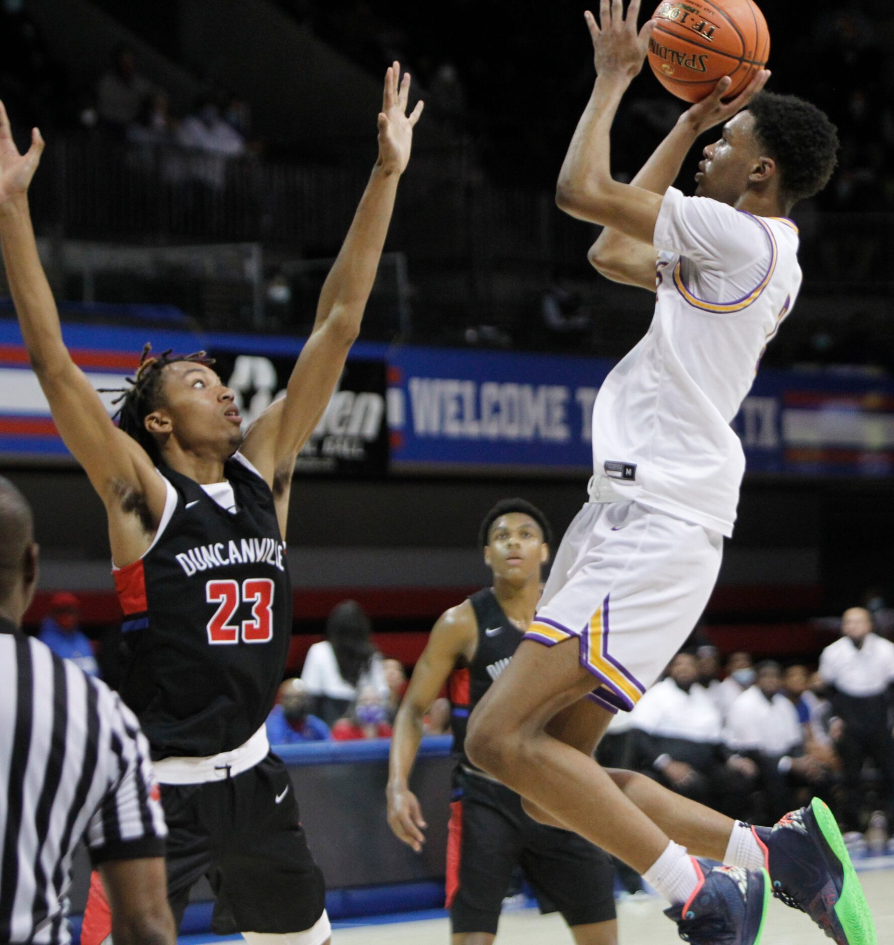 Richardson guard Rylan Griffen (3) scores on a jumper over the defense of Duncanville...