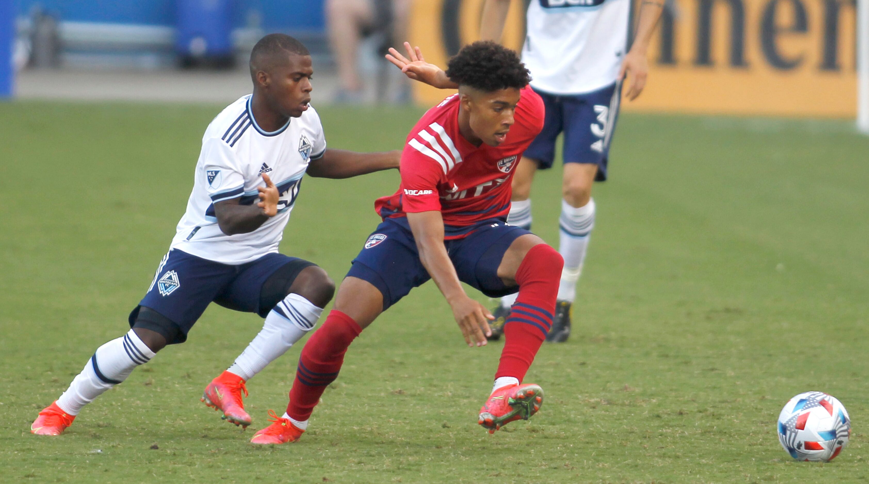 FC Dallas defender Justin Che (32), right, cuts toward the ball as Vancouver midfielder...