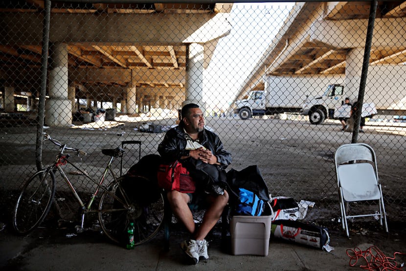 A man who called himself "J.R." sat with his belongings outside Dallas' shuttered Tent City...