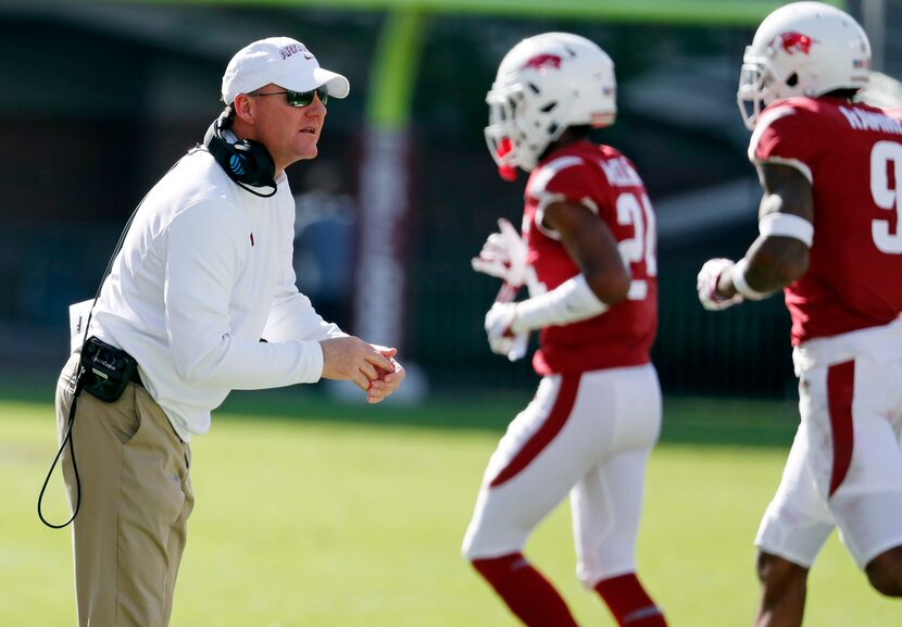 FILE - Arkansas head coach Chad Morris encourages his players as they leave the field in the...