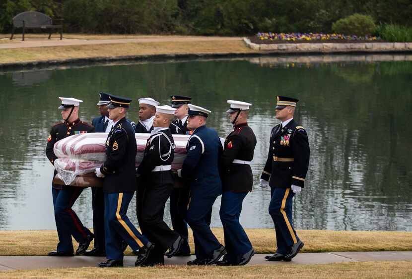 The flag-draped casket of President George H.W. Bush is carried to a burial plot close to...