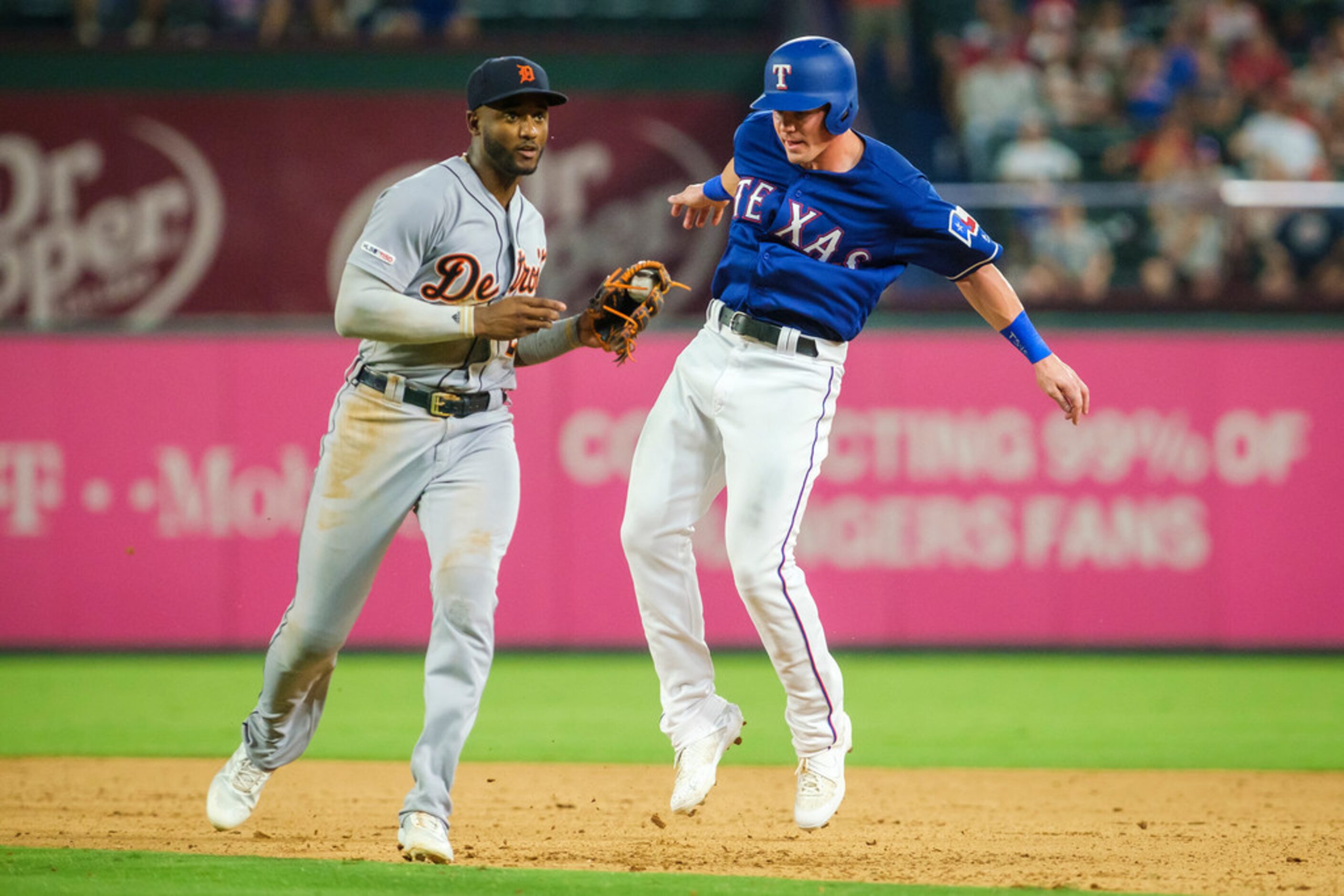 Detroit Tigers second baseman Niko Goodrum (28) puts a tag on Texas Rangers outfielder Scott...