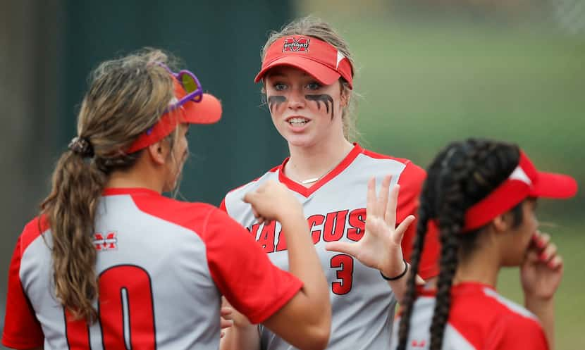 Flower Mound Marcus' Haidyn Sokoloski (3) fist bumps Bella Hernandez (10) during player...