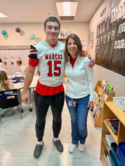 Flower Mound Marcus linebacker Brock Golwas takes a photo with Bridlewood Elementary second...