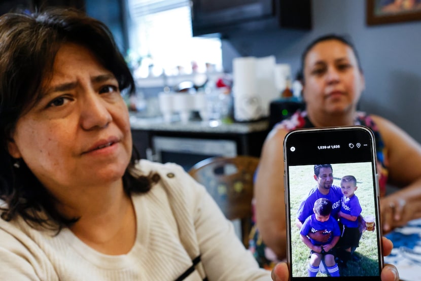 Maria Gaucin, (left), and Josephine Montelongo Raza, show a photo of an archived photo of...