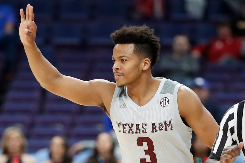 Texas A&M's Admon Gilder gestures after making a 3-point basket during the first half in an...