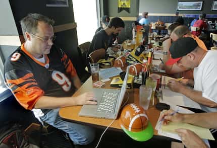 Brian Sherman, left, and his friends draft players to their fantasy football teams in 2010...