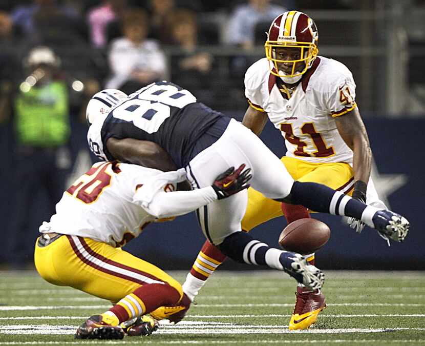 Dallas Cowboys wide receiver Dez Bryant (88) fumbles the ball after being hit by Washington...