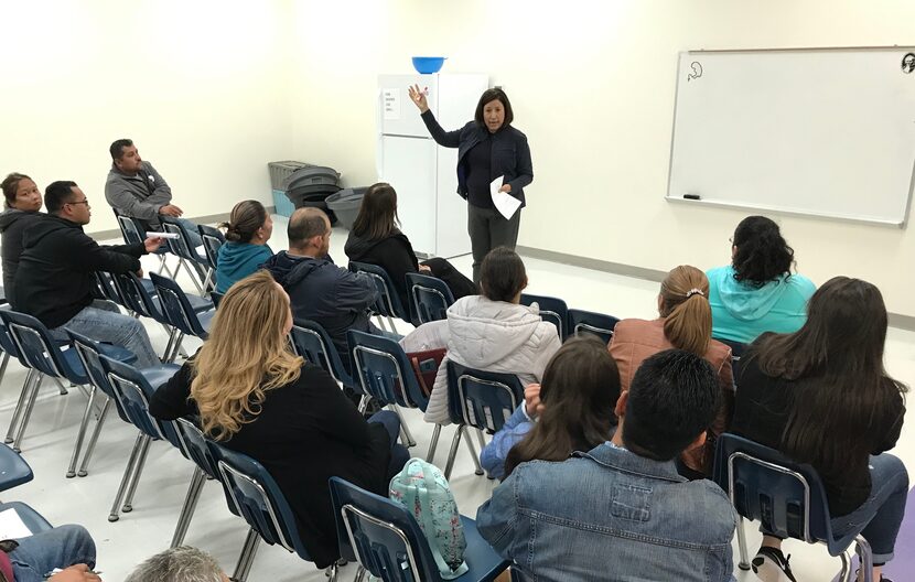 Josephine Lopez-Paul, the lead organizer for Dallas Area Interfaith, addresses a group of...