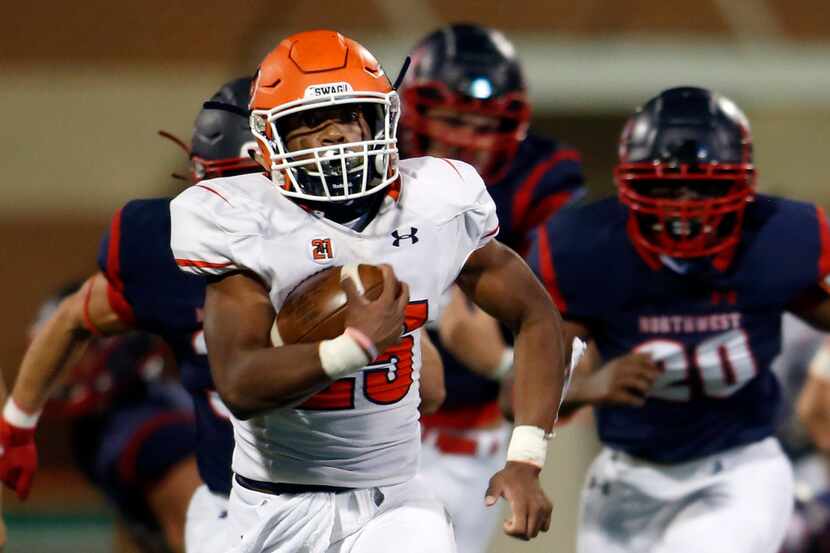 McKinney North running back Jayden Smith (25) leaves a sea of Northwest defenders in pursuit...