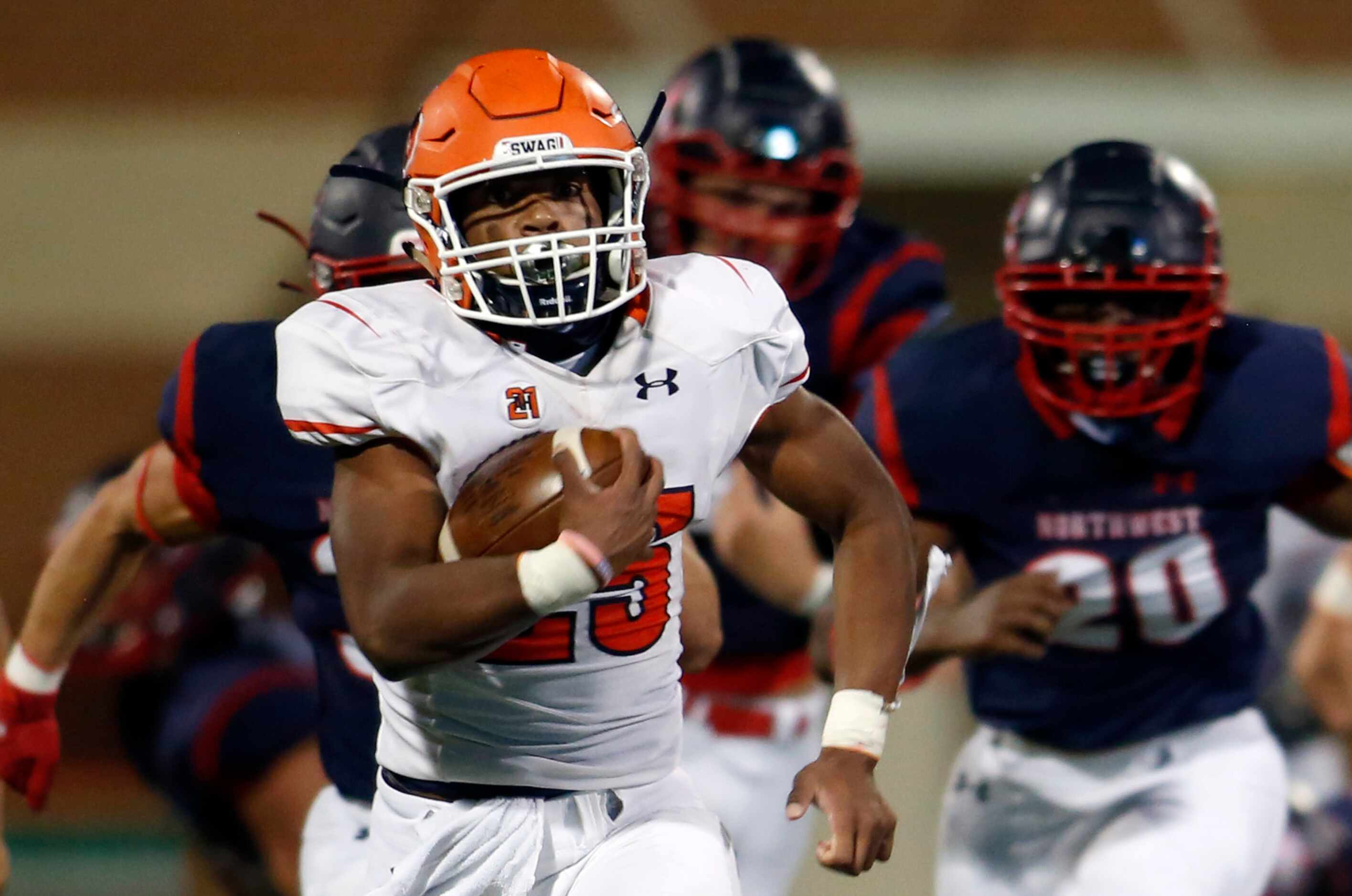 McKinney North running back Jayden Smith (25) leaves a sea of Northwest defenders in pursuit...